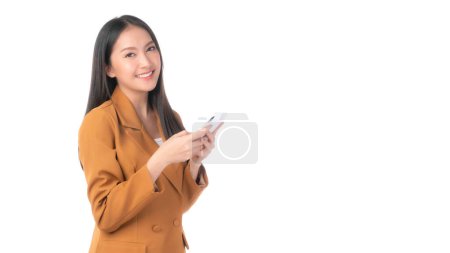 Foto de Beautiful Asian woman cute girl playing a smart phone isolated on white background - mobile phone uses a online banking for pay online shopping - Imagen libre de derechos