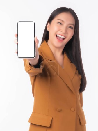 Foto de Beautiful Asian young woman ,Excited surprised girl showing smart phone with blank screen , white screen isolated on white background , Mock Up Image - Imagen libre de derechos