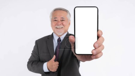 Téléchargez les photos : Asian senior businessman , old man with suit feel happy good health showing big smart phone with blank screen , white screen isolated on white background , Mock Up Image - en image libre de droit