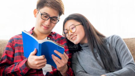 Photo for Portrait pretty woman and young man wearing eyeglasses talking and reading book with joyful together at home - young couple education concept - Royalty Free Image