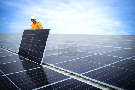 Photo for Experienced worker installing solar panels for sustainable energy production. - Royalty Free Image