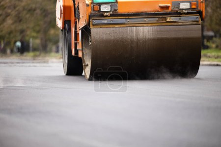 Photo for Road or infrastructure construction. Asphalt paving machine with steamroller working on new layer. - Royalty Free Image