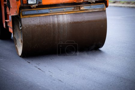 Photo for Close up view of asphalt paving machine steamroller working on the new road. - Royalty Free Image