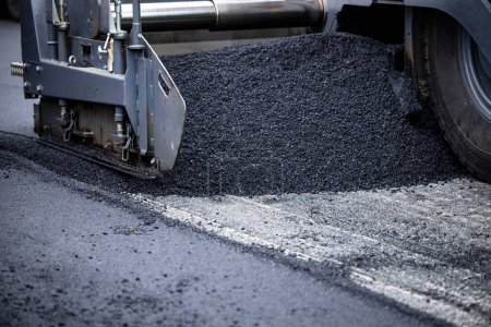 Photo for Paver machine adding new asphalt on the road. - Royalty Free Image
