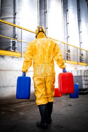Photo for Working in chemicals factory warehouse carrying acid tanks. - Royalty Free Image
