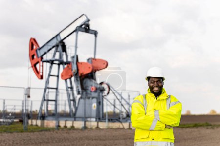 Photo for Portrait of professional worker in protective work wear standing in oil field. - Royalty Free Image