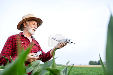 Photo for Farmer using modern drone technology to monitor crops growth in the field. - Royalty Free Image