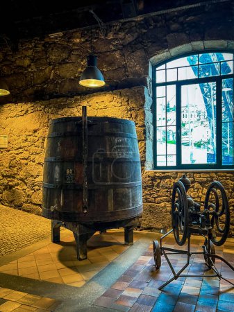 Foto de Porto, Portugal - December 5, 2022: Branch of Port wine producer Burmester, wine cellars open to public for guided tours and tastings in Vila Nova de Gaia at Douro river. Winery in port of XIX century - Imagen libre de derechos