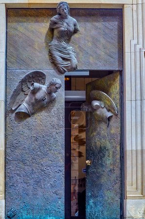 Photo for Warsaw, Poland, August 9, 2022: Four-meter bronze entrance doors. sculptor - Igor Mitorai. postmodern bas-reliefs of Mary and two angels. installed in 2009. at the Jesuit Church in Warsaw, Poland. - Royalty Free Image