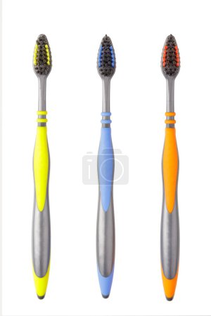 Photo for A close up of three tooth brushes isolated on a white background - Royalty Free Image