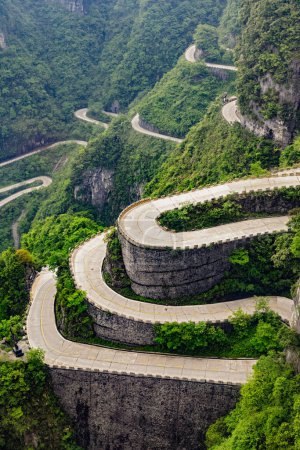 Photo for The curvy road leading to the cave at Tianmen Mountain.  There are 99 switchbacks, nine being a lucky number is China, along the way. Tianmen Mountain National Forest Park, Hunan, China - Royalty Free Image