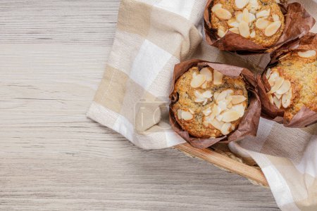 Photo for Banana Nut Muffins resting on a wooden table - Royalty Free Image