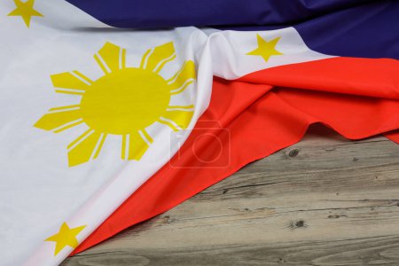 Foto de Philippine Flag draped over a wooden background with copy space - Imagen libre de derechos