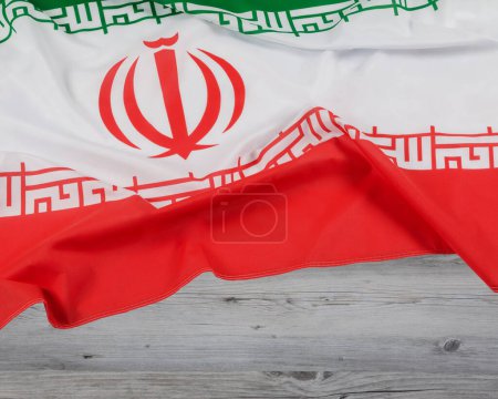 The flag of the Islamic Republic of Iran with wooden background and copy space