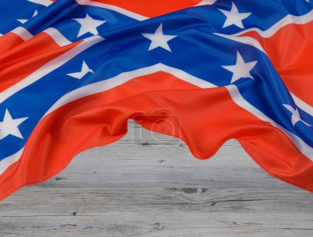 Photo for The official flag of the Confederate States of America also known as The Tennessee Battle Flag with a wooden background and copy space - Royalty Free Image