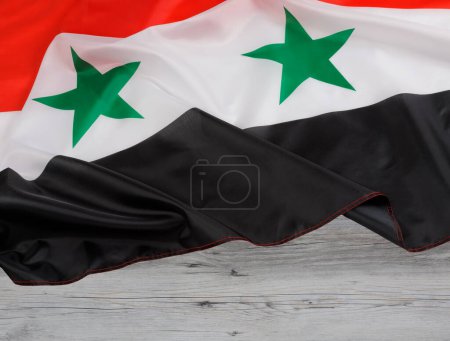 Photo for Syria, officially the Syrian Arab Republic is a Western Asia country, Syria flag with wooden background and copy space - Royalty Free Image