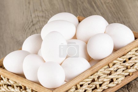 Photo for Close up of  a basket of fresh raw White Eggs with  copy space - Royalty Free Image