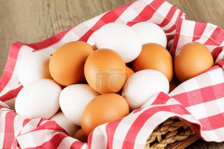 Photo for Close up of  a basket of fresh raw White and Brown Eggs with  copy space - Royalty Free Image