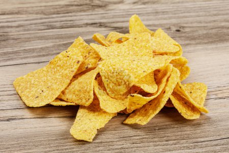Photo for Close up of delicious Roasted Corn Tortilla or Nacho Chips on a wooden background with copy space - Royalty Free Image