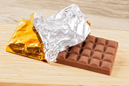 Photo for Close up of a delicious Milk Chocolate Candy Bar Isolated on a wooden background with copy space - Royalty Free Image