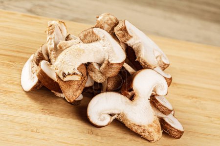 Photo for Delicious Sliced Shiitake Mushrooms isolated on a wooden background with copy space - Royalty Free Image