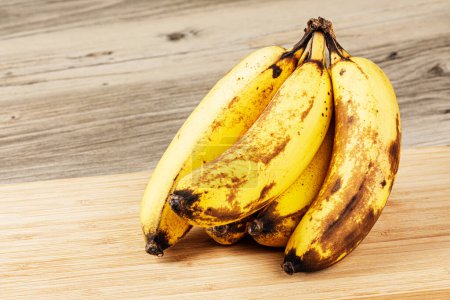 Close up of Over Ripe Bananas isolated of a wooden background with copy space