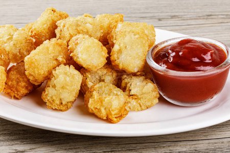 Photo for Close up of delicious Tater Tots on a wooden background with copy space - Royalty Free Image