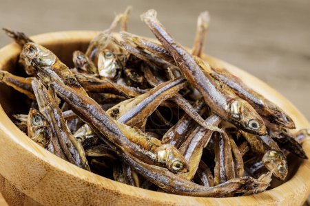Photo for A wooden bowl ofSmall Dried Fish considered a delicatessen in most Asian Countries, Philippines, Southeast Asia - Royalty Free Image