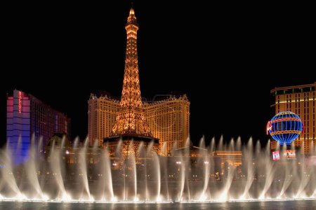 Photo for Las Vegas casino. Fountains outside the Bellagio Casino in Las Vegas, Nevada, USA. A model of the Eiffel Tower can also be seen. - Royalty Free Image