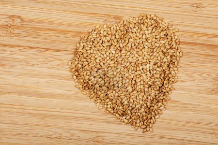 Photo for Close up of Roasted Flax Seeds shaped as a heart a healthy and delicious supplement to any meal copy space - Royalty Free Image