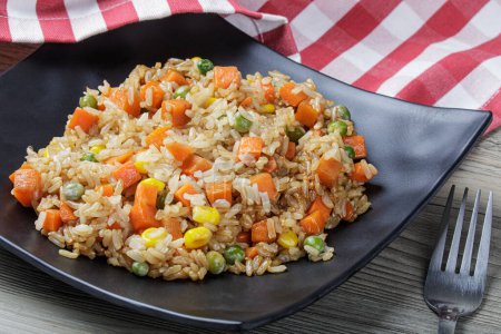 Photo for Close up of both healthy and delicious homemade stir fried rice on a wooden background with copy space - Royalty Free Image