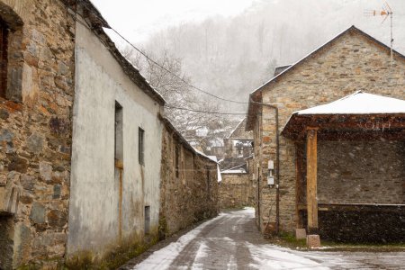 Photo for Snowy stone streets and buildings in a picturesque town in the Spanish province of Len, called Colinas del Campo - Royalty Free Image