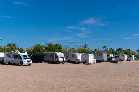 Photo for Motorhomes and campervans parking at the free aire in Vinaros, Costa del Azahar Spain in beautiful sunshine and blue sky - Royalty Free Image