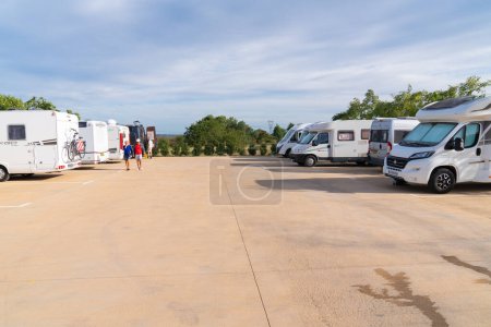 Photo for Motorhomes and campervans parked on the Area d`autocaravanes aire in La Selva del Camp, Tarragona Province, Spain using the water and waste services and parking - Royalty Free Image