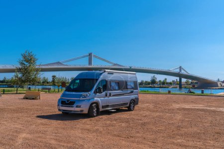 Photo for Campervan parked by Ebro River bridge, Ebro delta, Tarragona, Catalonia, Spain in the sunshine - Royalty Free Image