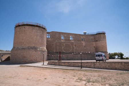 Photo for Campervan on a free spanish aire for motorhomes with the castle at Castillo de Garcimunoz Cuenca, Castile-La Mancha, Spain - Royalty Free Image