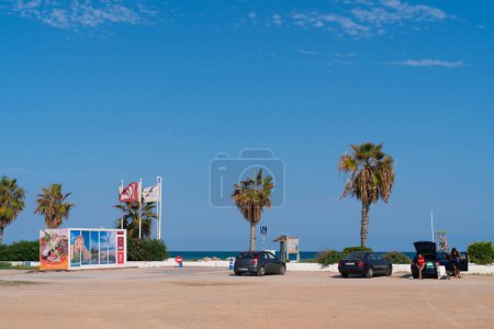 Photo for Parking by the beach with palm trees next to the motorhome aire El Puig De Santa Maria, north of La Pobla de Farnals, Spain on Monday 11th September 2023 - Royalty Free Image