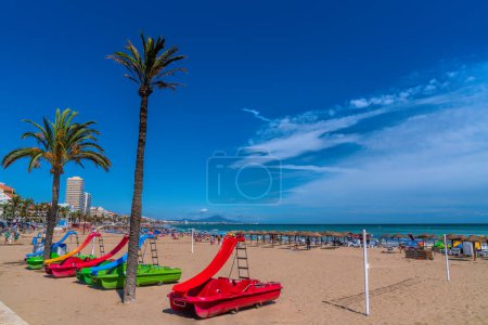 Peniscola beach Spain Costa del Azahar with colourful pedalos in summer tourist destination