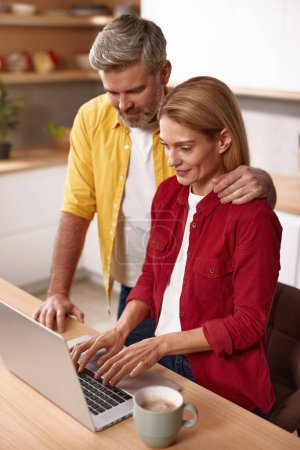 Photo for Mature Couple Using Laptop Together. Husband And Wife Sharing Computer Social Network, Smiling And Searching For Funny Content. Technologies And People Concept - Royalty Free Image