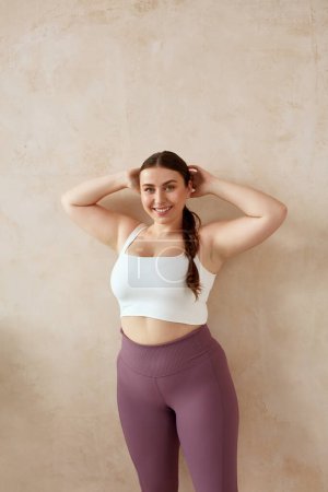 Photo for Smiling Woman Relaxing After Yoga. Overweight Female Posing After Yoga Session At Home. Attractive Girl In Sportswear Spending Free Leisure Time - Royalty Free Image