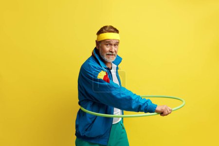 Photo for Senior Sportsman Holding Hula Hoop. Emotional Cheerful Gymnast Grandpa With Happy Emotions, Exercises For Fit Figure. Body Care, Hobby, Weight Loss, Game process - Royalty Free Image