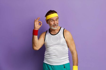 Photo for Ok Gesture. Mature Man Making Ok Symbol With Fingers, Approving, Satisfied. Indoor Studio Shot Isolated On Violet Background - Royalty Free Image