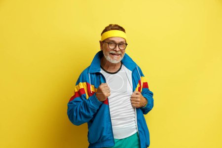 Photo for Smiling Man Posing Studio. Portrait of Happy Senior Man Standing and Smiling. Indoor Studio Shot, Isolated on Yellow Background - Royalty Free Image