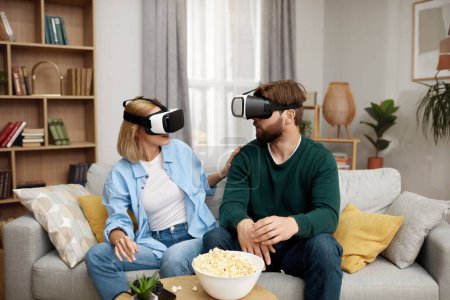 Photo for Happy Couple Playing VR Games. Boyfriend And Girlfriend Enjoying Virtual Reality In Their Apartment. Cheerful People Having Fun With New Trends Technology. Gaming concept - Royalty Free Image