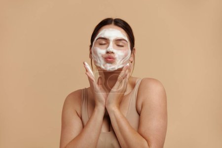 Foto de Cleaning Face. Caucasian Plus Size Woman Cleaning Facial Skin with Foam Soap. Happy Girl Cleansing Face Applying Facial Cleanser Closeup. High Resolution - Imagen libre de derechos