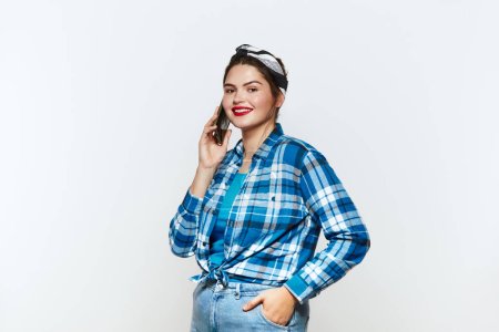 Plus Size Woman Calling Smartphone. Chubby Girl Smiling And Talking Cellphone, Chatting, Enjoying Mobile Service. Empty Copy Space for Advertisement, Indoor Studio Shot 
