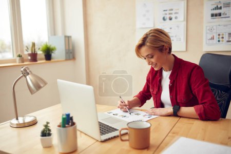 Businesswoman Working Office. Positive Lady Examining Documents at Computer Table. Female Person Sitting At Workplace In Modern Office. Career Concept 