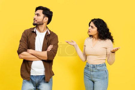 Photo for INDIAN COUPLE DISAGREEMENT Concept With Man Ignoring And Woman Arguing On Yellow Background - Royalty Free Image