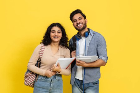Photo for Happy Students Smiling With Notebooks Over Yellow Background, Casual Education Concept, Diverse Young People, Millennial Trend - Royalty Free Image