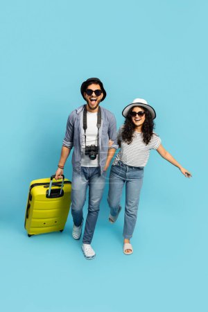 Happy Couple On Vacation Laughing With Luggage, Summer Travel, Casual Style, Blue Background, Leisure Activity, Tourist, Sunglasses, Hat